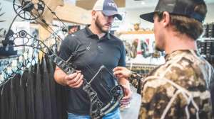 Bow shop salesman showing new bow 190423 105345 e991f65cda8cad0d03a7ea8cd2674507