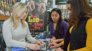 Customers 1 women in gun shop buying at counter NSSF photo f4159788da6a13a05c7755e7e3b29890 200107 162504
