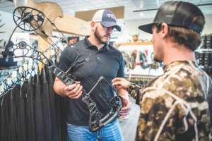 Bow shop salesman showing new bow 190423 105345 e991f65cda8cad0d03a7ea8cd2674507