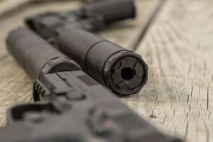 TR Suppressor story pistol with suppressor beauty on table PHOTO BY MATT PORTER